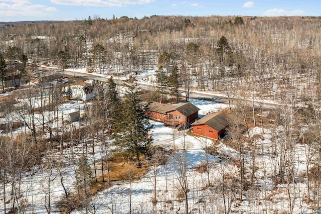 snowy aerial view featuring a view of trees