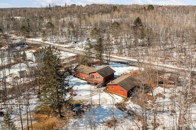 snowy aerial view featuring a view of trees