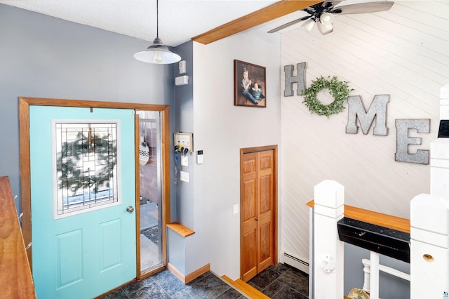 foyer with baseboards, lofted ceiling, ceiling fan, stone finish floor, and a baseboard heating unit