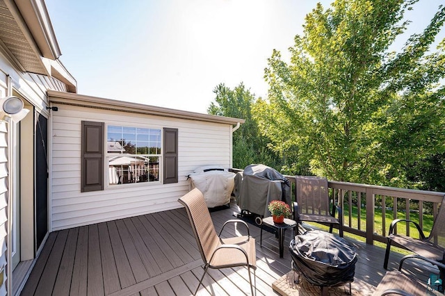 wooden terrace featuring area for grilling