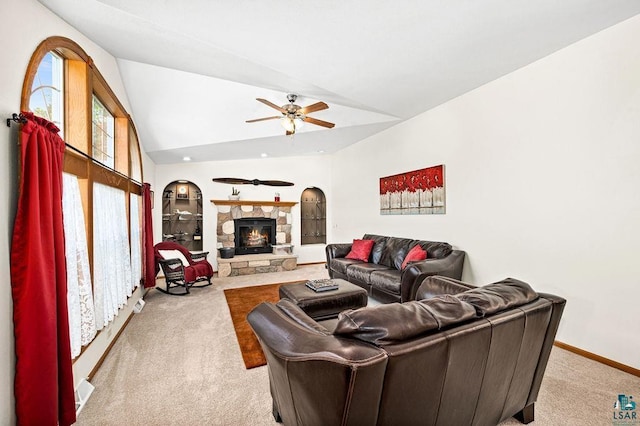 living room featuring ceiling fan, baseboards, carpet floors, a fireplace, and high vaulted ceiling