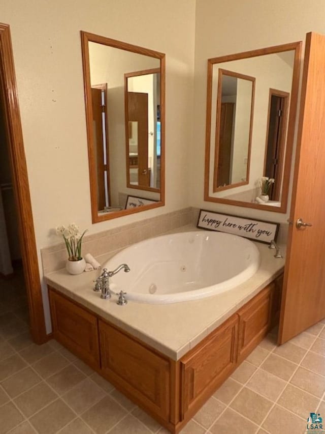 full bathroom with tile patterned floors and a whirlpool tub