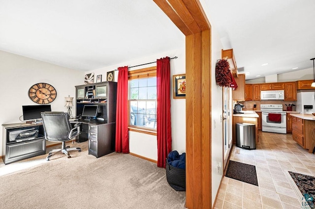 office area with baseboards, lofted ceiling, and light carpet