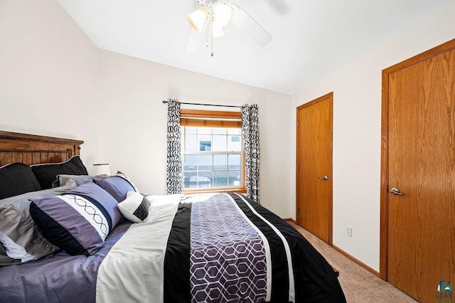 carpeted bedroom with baseboards, a ceiling fan, and vaulted ceiling