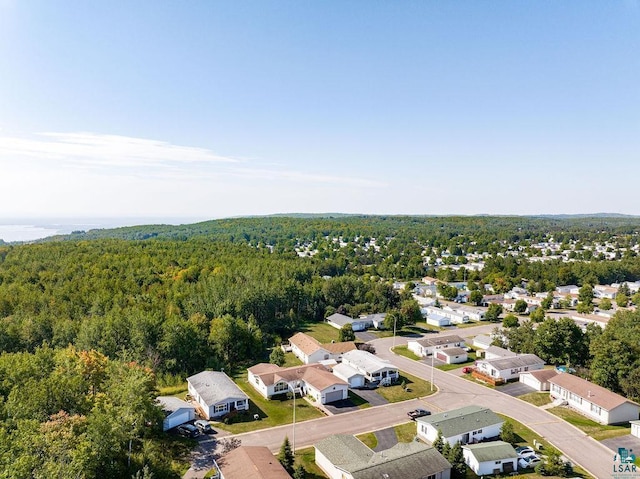 birds eye view of property with a view of trees and a residential view