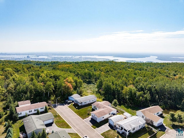 drone / aerial view featuring a forest view