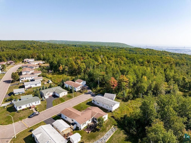 drone / aerial view with a forest view and a residential view