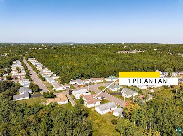 aerial view featuring a forest view and a residential view