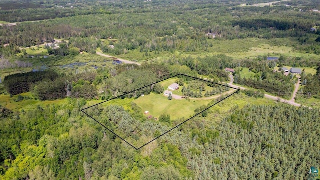 birds eye view of property with a forest view