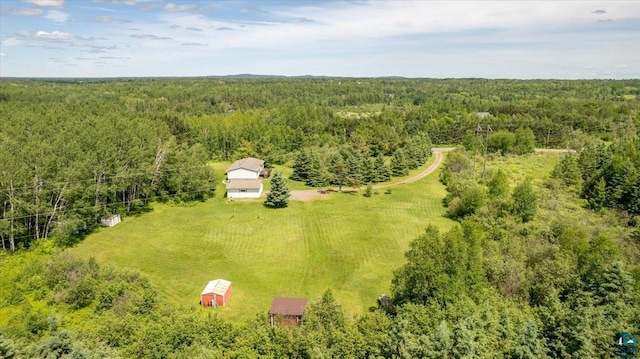 drone / aerial view with a wooded view