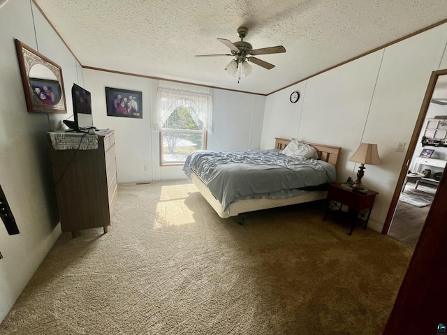 bedroom featuring light carpet, a textured ceiling, crown molding, and ceiling fan