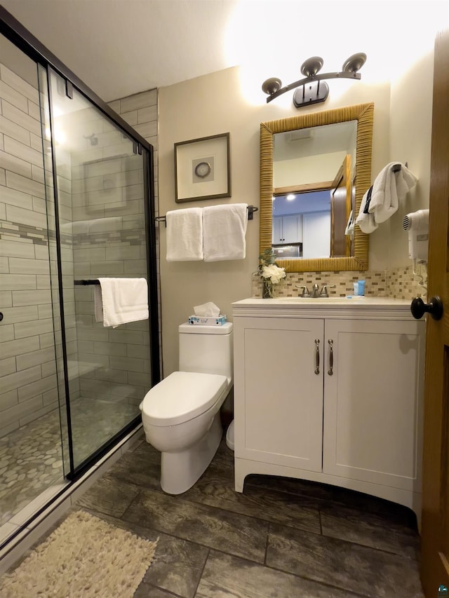 full bathroom featuring tasteful backsplash, toilet, a stall shower, and vanity