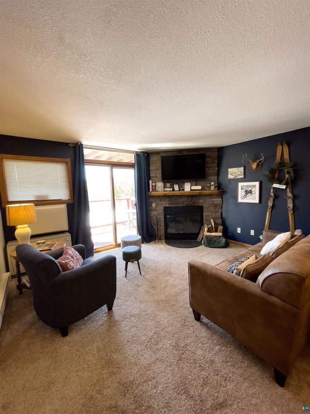 living room with carpet floors, a textured ceiling, and a fireplace