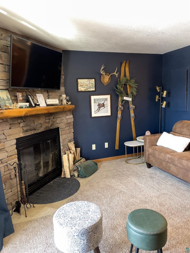 living room featuring baseboards, carpet floors, a textured ceiling, and a stone fireplace