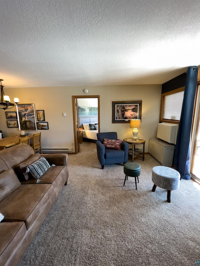 living room with a notable chandelier, baseboard heating, a textured ceiling, and carpet floors