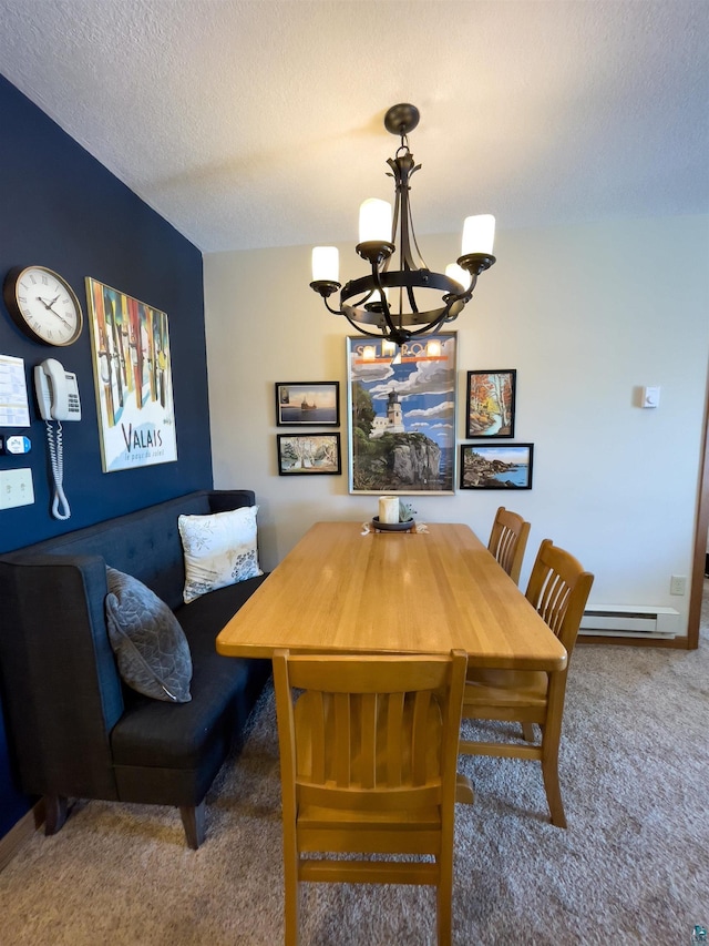 carpeted dining space featuring a chandelier, baseboard heating, and a textured ceiling