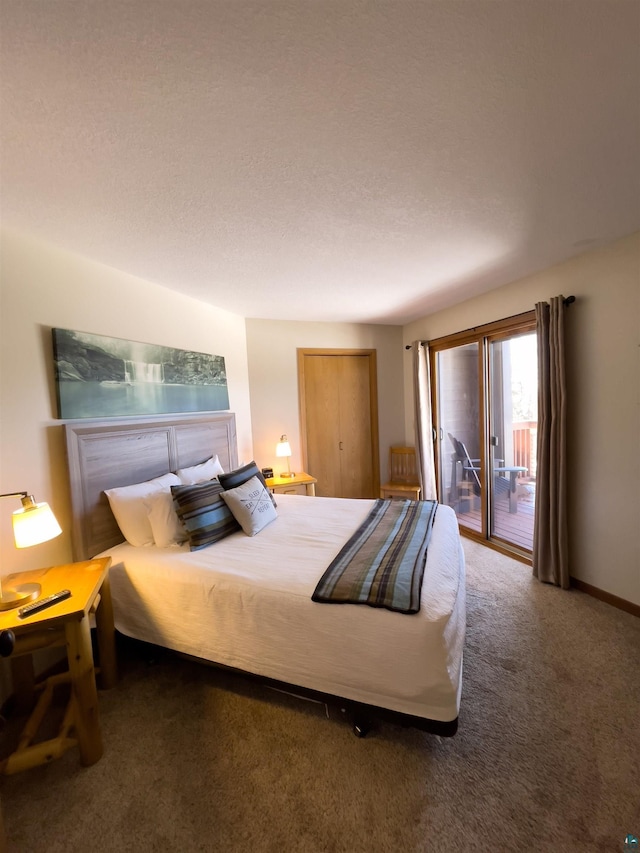 carpeted bedroom featuring baseboards and access to outside