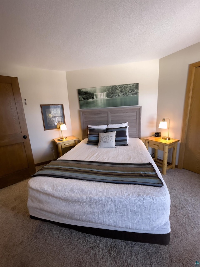 bedroom featuring a textured ceiling and carpet