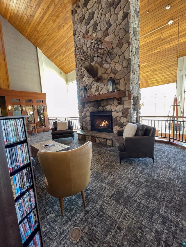 living room with a stone fireplace, carpet, wood ceiling, and high vaulted ceiling