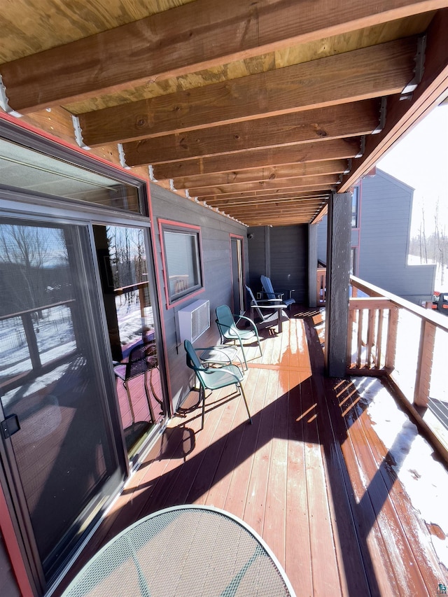 wooden deck featuring an AC wall unit