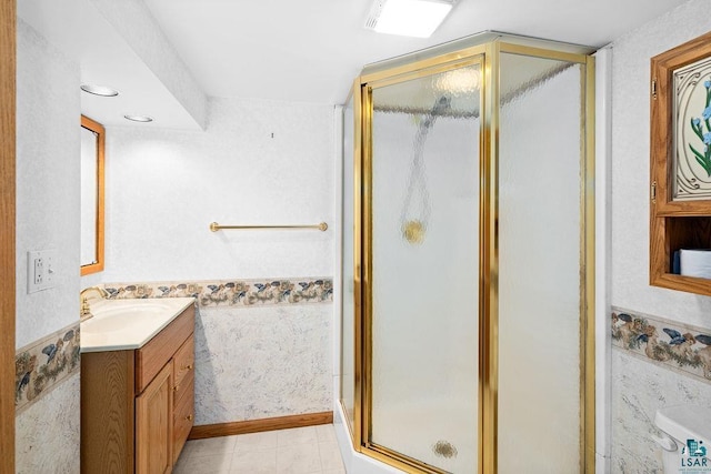 bathroom featuring a stall shower and vanity