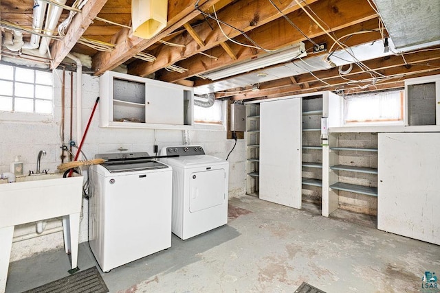 basement with a wealth of natural light and washing machine and clothes dryer