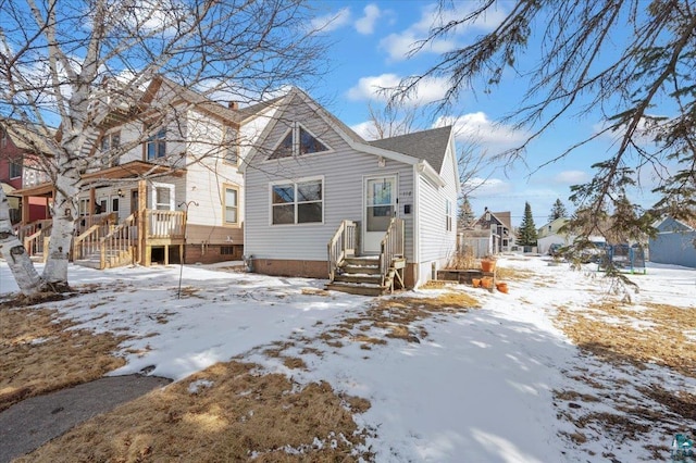 view of snow covered rear of property