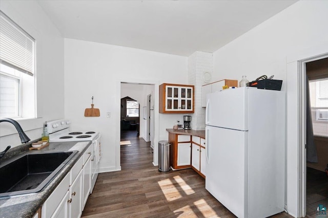 kitchen with white cabinetry, white appliances, dark wood-style flooring, and a sink