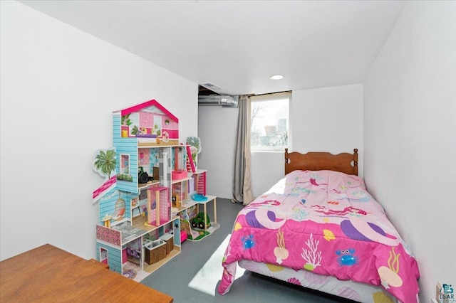 bedroom featuring finished concrete flooring and a wall unit AC