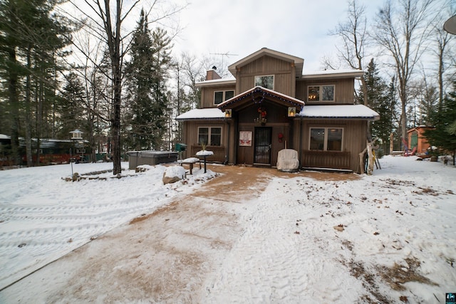 rustic home featuring a chimney and a hot tub