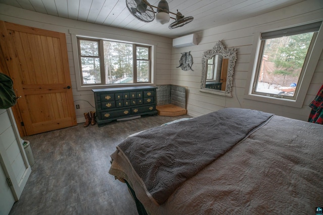 bedroom featuring multiple windows, wood finished floors, wooden ceiling, and a wall mounted AC