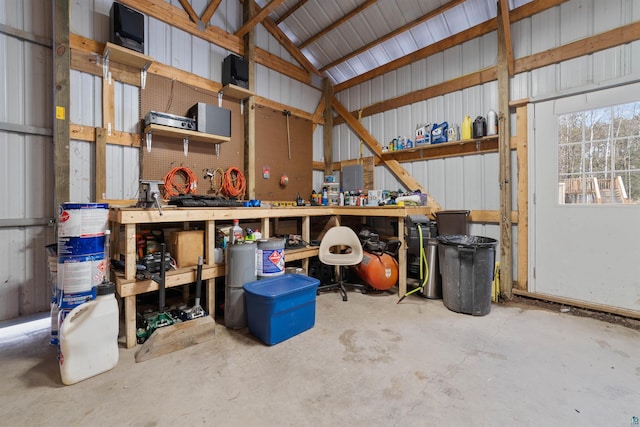 garage with a workshop area and metal wall