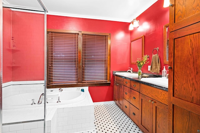 bathroom featuring double vanity, a garden tub, and a sink