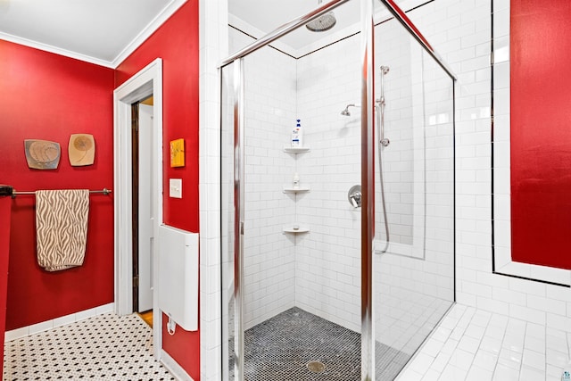 bathroom featuring a stall shower, crown molding, and baseboards