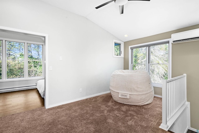 living area featuring baseboards, a wall mounted AC, vaulted ceiling, carpet flooring, and baseboard heating