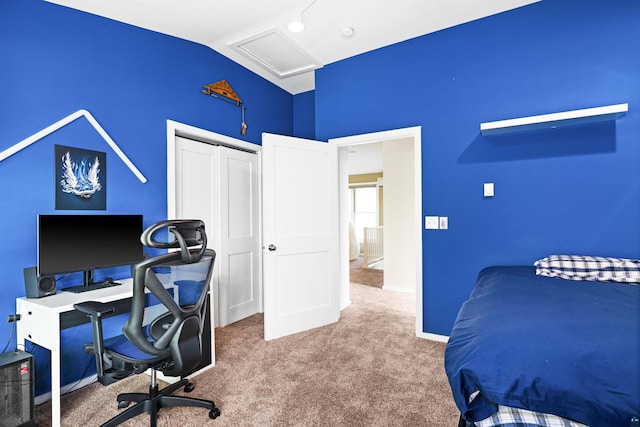 carpeted bedroom with attic access, baseboards, a closet, and lofted ceiling