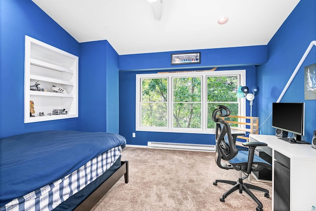 bedroom featuring baseboards, baseboard heating, and carpet flooring