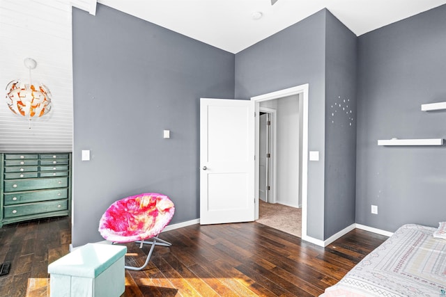 bedroom with baseboards and wood-type flooring