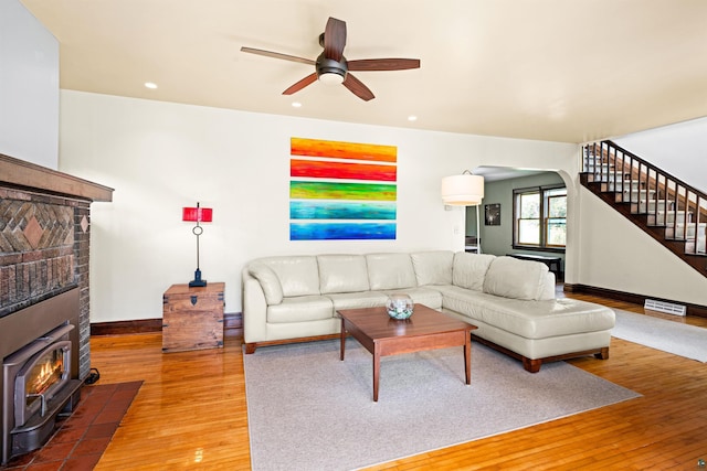 living room featuring visible vents, baseboards, stairway, hardwood / wood-style floors, and recessed lighting