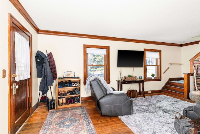 living room with crown molding, stairway, and a wealth of natural light