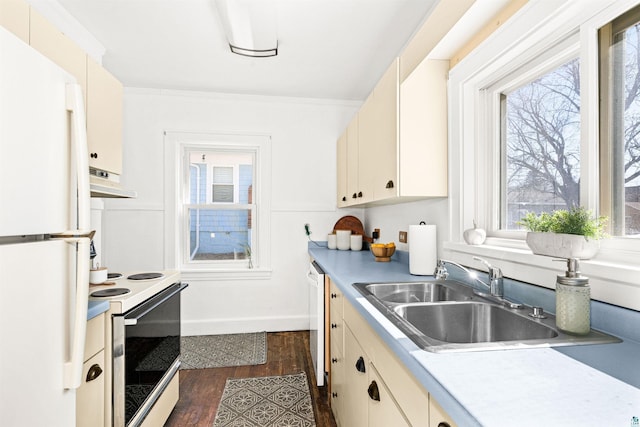 kitchen with white appliances, light countertops, under cabinet range hood, and a sink