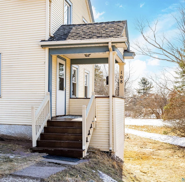 property entrance with roof with shingles