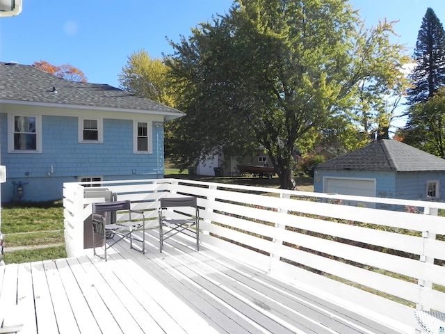 deck featuring an outdoor structure and a garage