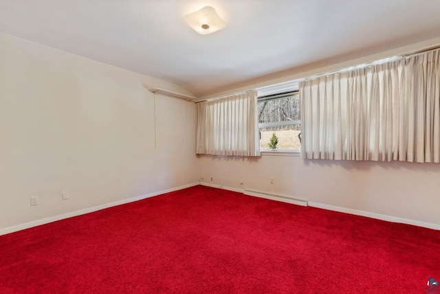 unfurnished room with lofted ceiling, baseboards, dark colored carpet, and a baseboard radiator