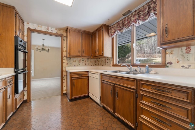 kitchen with light countertops, white dishwasher, brown cabinetry, dobule oven black, and a sink