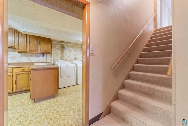 interior space featuring washer and dryer, baseboards, and a paneled ceiling