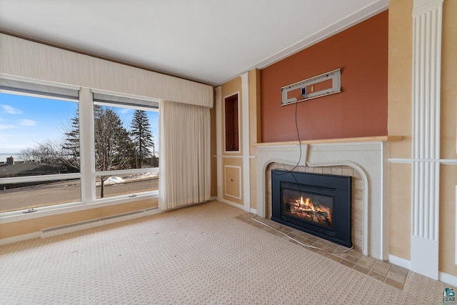 unfurnished living room with a baseboard heating unit, a fireplace with flush hearth, and carpet floors