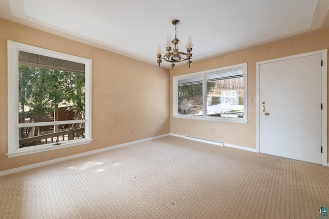 carpeted empty room featuring baseboards, baseboard heating, and an inviting chandelier