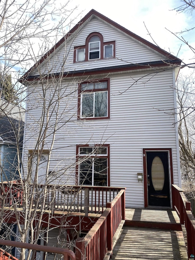 back of house featuring a deck