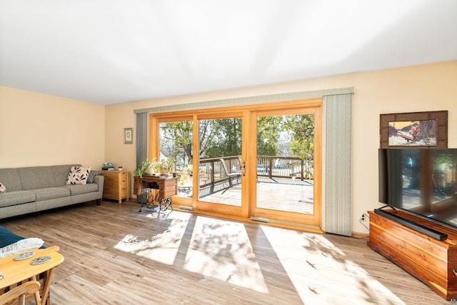 living area featuring visible vents and wood finished floors